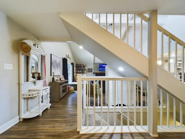 hall featuring dark hardwood / wood-style flooring and lofted ceiling