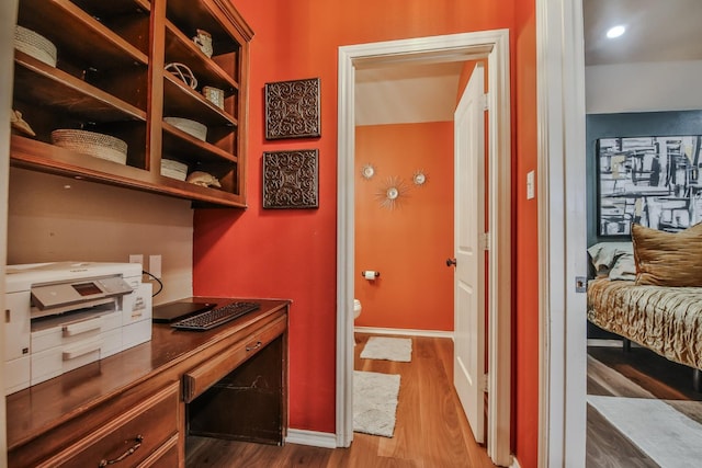 office area featuring hardwood / wood-style flooring and built in desk