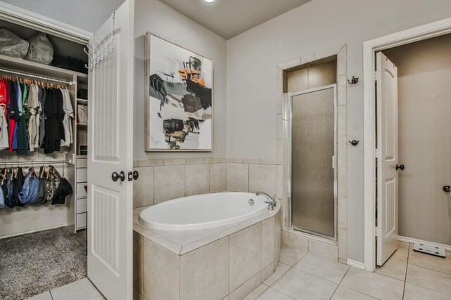 bathroom featuring tile patterned flooring and shower with separate bathtub