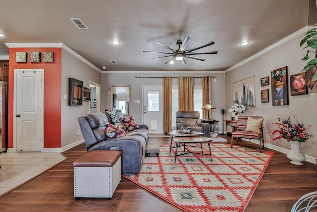 living room featuring crown molding, ceiling fan, and hardwood / wood-style flooring