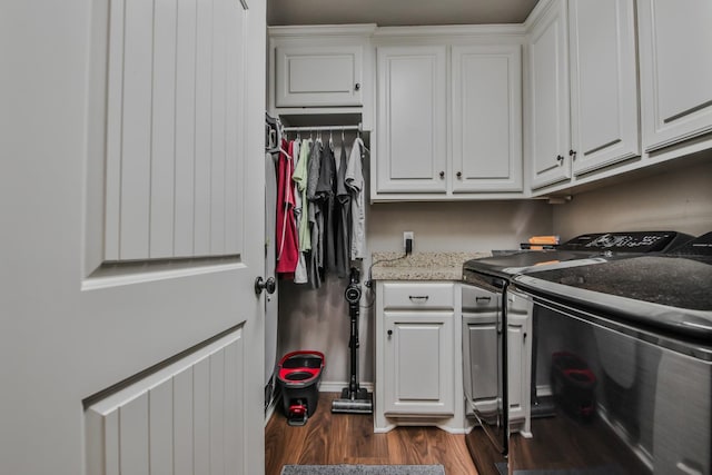 washroom with cabinets, separate washer and dryer, and dark hardwood / wood-style floors