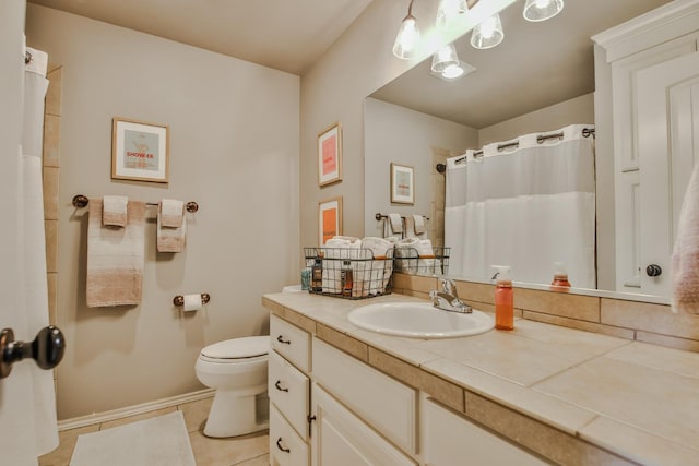 bathroom featuring tile patterned flooring, vanity, and toilet