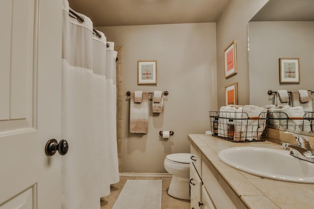 bathroom featuring tile patterned flooring, vanity, curtained shower, and toilet