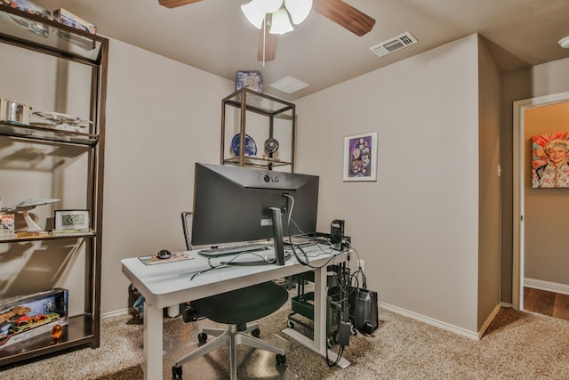 carpeted home office featuring ceiling fan