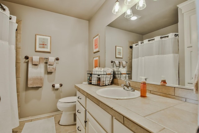 bathroom with vanity, tile patterned floors, and toilet