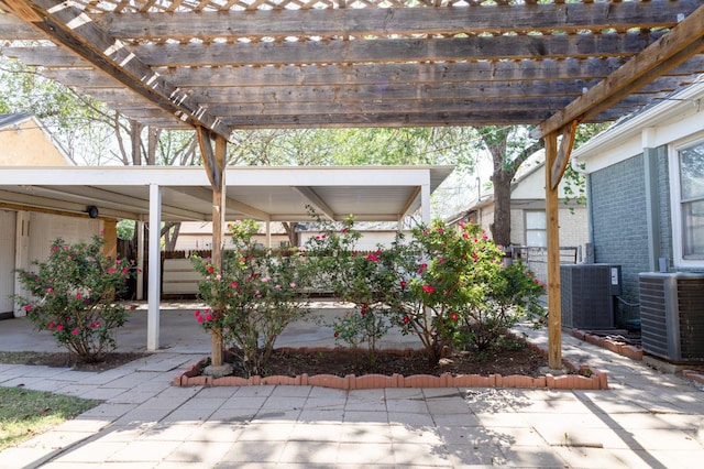 view of patio with central air condition unit and a pergola