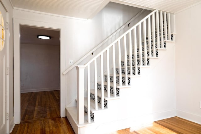 stairs featuring hardwood / wood-style floors