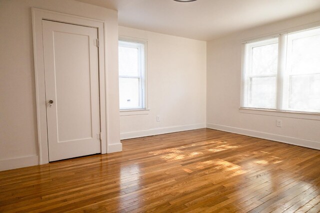 empty room featuring plenty of natural light and light hardwood / wood-style floors