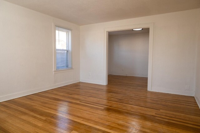 spare room featuring hardwood / wood-style flooring