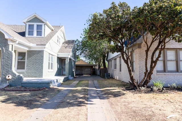 view of side of property featuring a garage and central AC