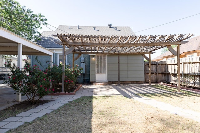 back of house with a yard and a pergola