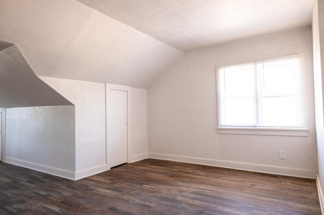 bonus room featuring dark hardwood / wood-style flooring and vaulted ceiling