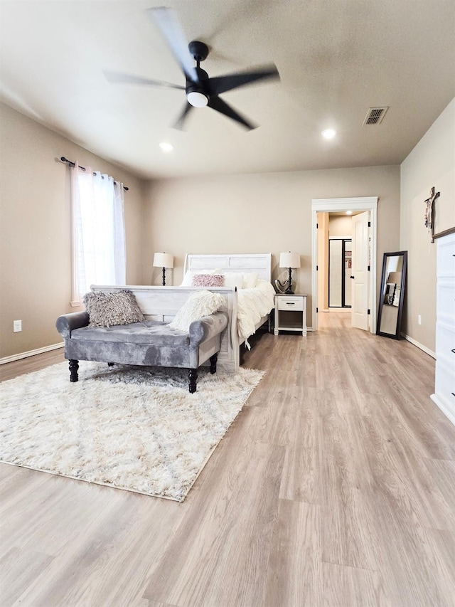 bedroom with light hardwood / wood-style floors and ceiling fan