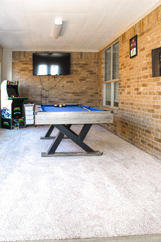 game room featuring brick wall