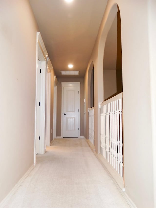 hallway with light colored carpet