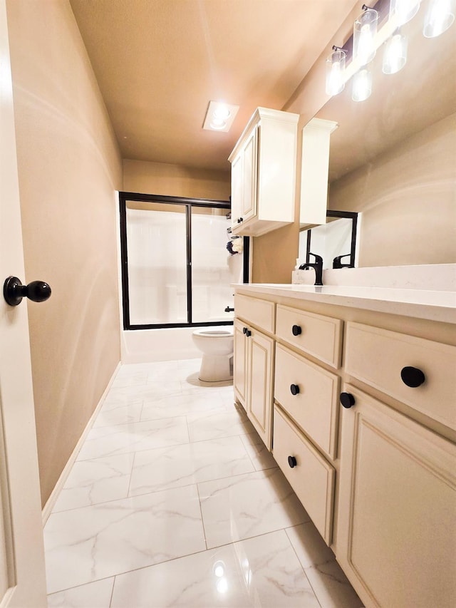 full bathroom with bath / shower combo with glass door, vanity, and toilet