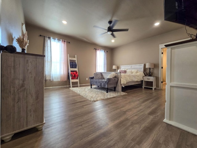 bedroom with dark hardwood / wood-style flooring and ceiling fan