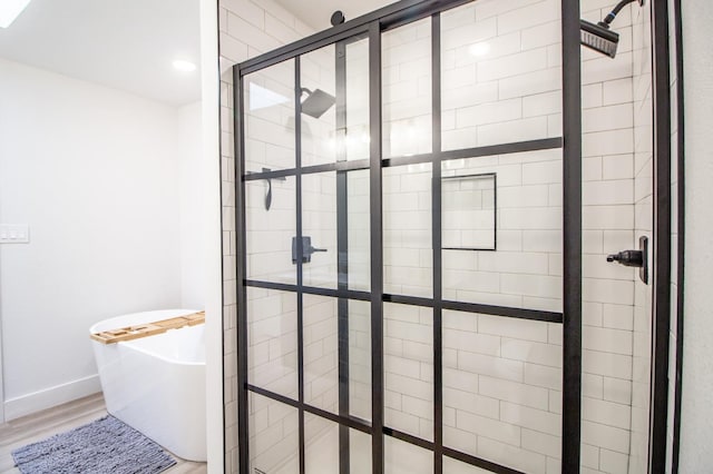 bathroom with hardwood / wood-style floors and plus walk in shower