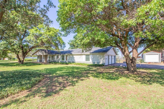 ranch-style home featuring a garage and a front lawn