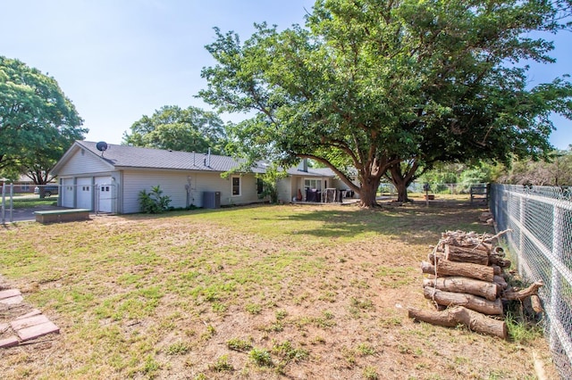 view of yard with a garage and cooling unit