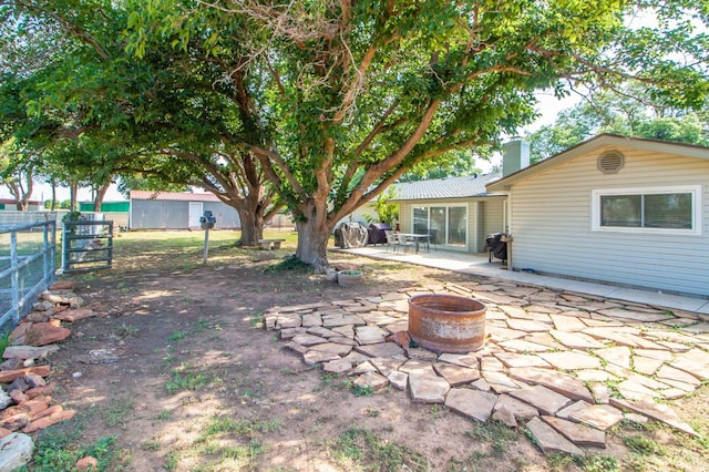 view of yard featuring a patio area and a fire pit