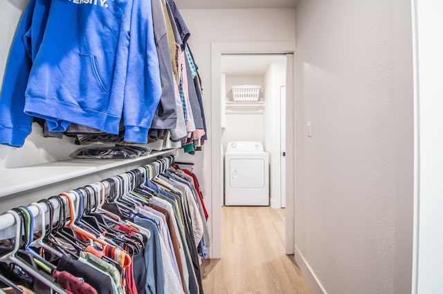 walk in closet featuring hardwood / wood-style flooring and washer / clothes dryer