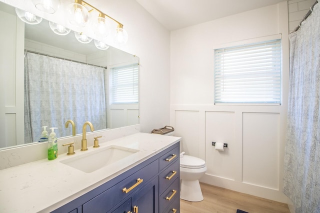 bathroom featuring hardwood / wood-style flooring, vanity, and toilet