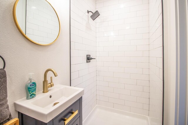 bathroom featuring vanity and a tile shower