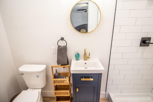 bathroom featuring vanity, toilet, and tiled shower