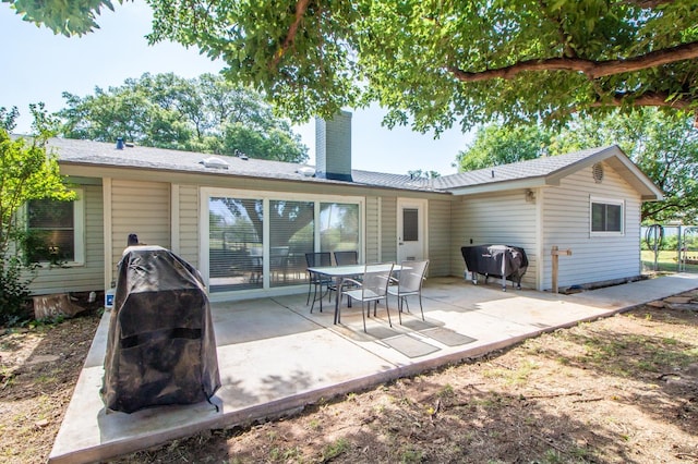 rear view of property featuring a patio area