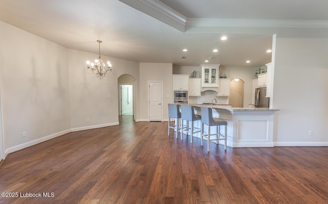 4003 124th St, Lubbock, TX 79423 - kitchen featuring arched walkways, appliances with stainless steel finishes, ornamental molding, white cabinetry, and recessed lighting