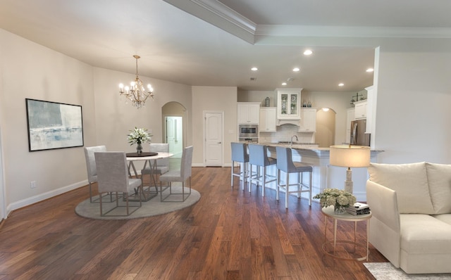 4003 124th St, Lubbock, TX 79423 - dining room featuring arched walkways, recessed lighting, dark wood-style flooring, crown molding, and a chandelier