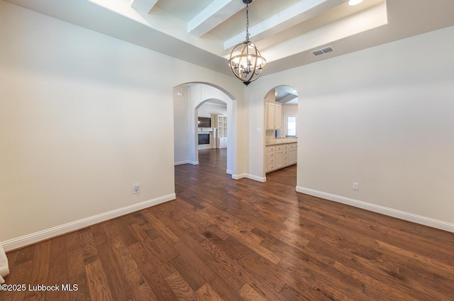 4003 124th St, Lubbock, TX 79423 - empty room featuring arched walkways, dark wood finished floors, beamed ceiling, and a chandelier