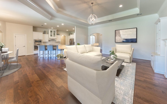 4003 124th St, Lubbock, TX 79423 - living area featuring arched walkways, a tray ceiling, crown molding, recessed lighting, and dark wood-style flooring