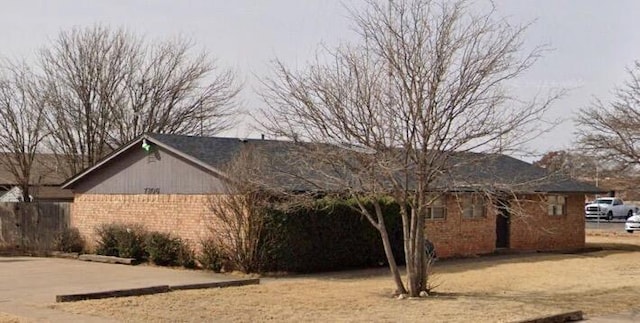 view of side of property with brick siding