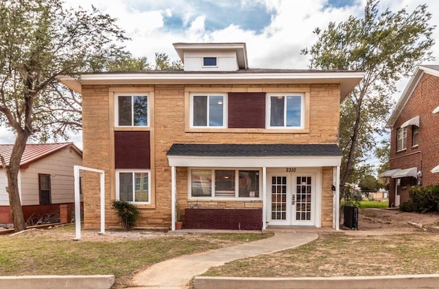 view of front of home featuring a front lawn and french doors