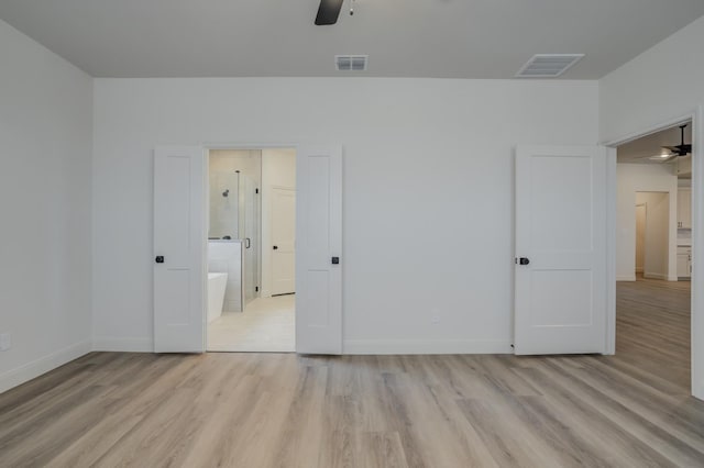 unfurnished bedroom featuring connected bathroom, light hardwood / wood-style floors, and ceiling fan