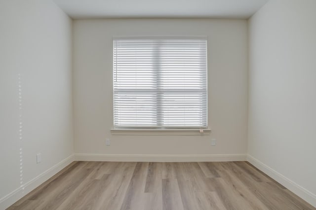 spare room featuring light hardwood / wood-style flooring