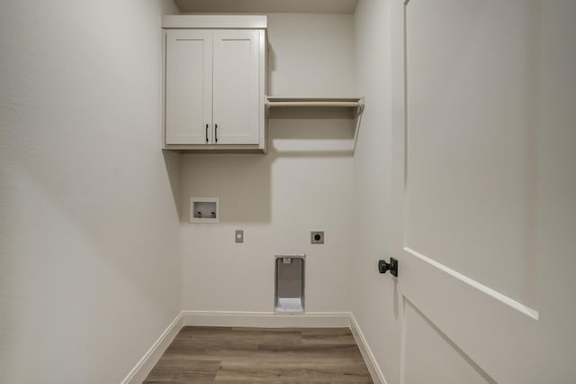 clothes washing area featuring cabinets, washer hookup, light wood-type flooring, and electric dryer hookup