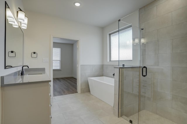 bathroom with vanity, a wealth of natural light, tile patterned floors, and separate shower and tub