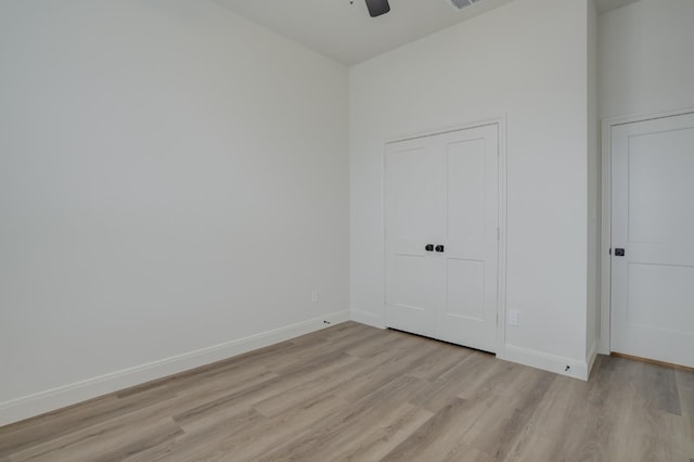 unfurnished bedroom with ceiling fan and light hardwood / wood-style flooring