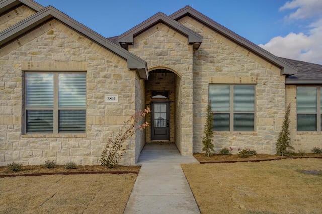 doorway to property with a yard