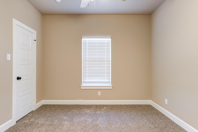 carpeted empty room with a ceiling fan and baseboards