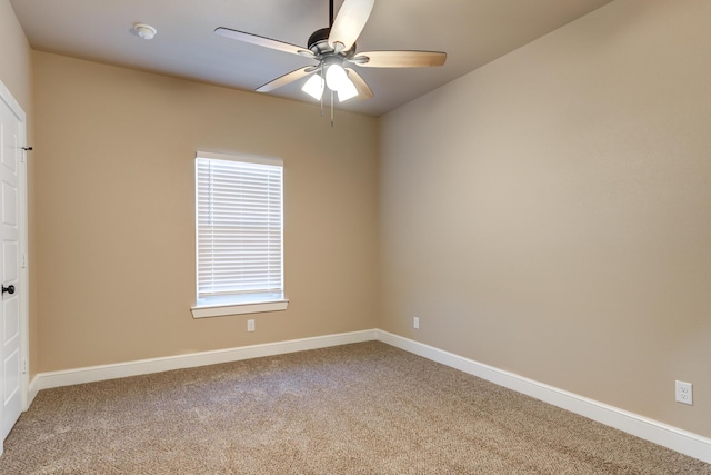 spare room with carpet floors, ceiling fan, and baseboards