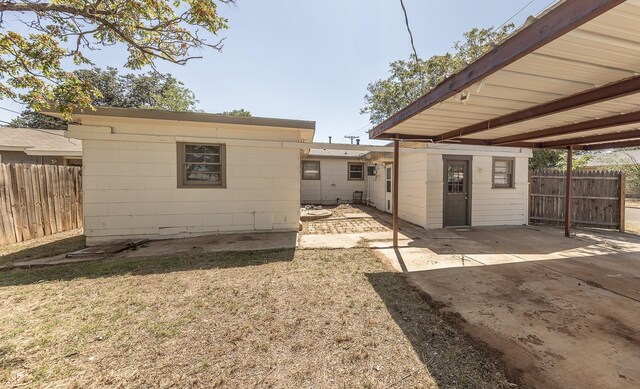 back of property featuring a storage shed