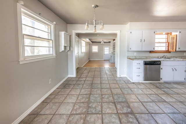 kitchen featuring white cabinetry, decorative light fixtures, stainless steel dishwasher, and a healthy amount of sunlight