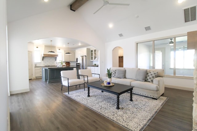 living room featuring beam ceiling, dark wood-type flooring, high vaulted ceiling, and ceiling fan