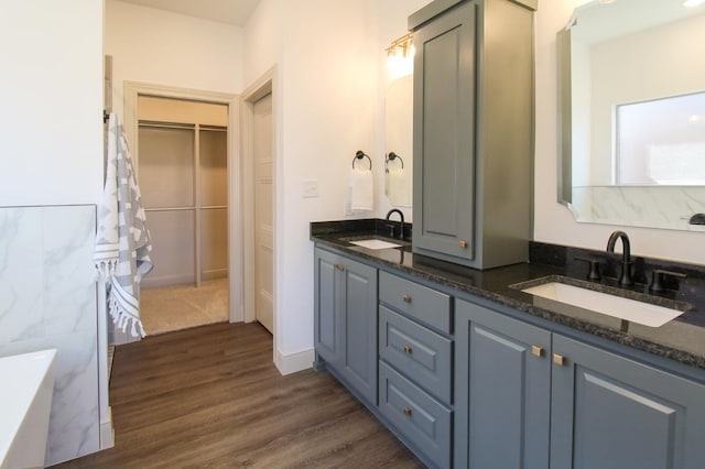 bathroom featuring vanity, hardwood / wood-style floors, and a bathtub