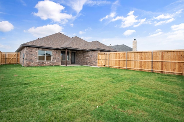 back of property featuring a yard and a patio