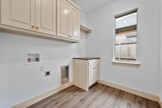 washroom with washer hookup, cabinets, light hardwood / wood-style floors, and hookup for an electric dryer